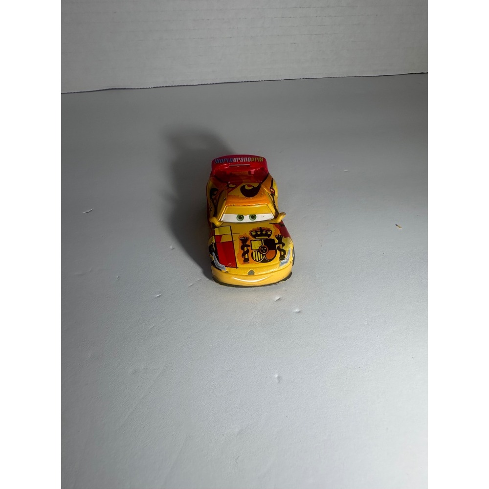 Disney Pixar Cars Miguel Camino World Grand Prix Diecast Toy Car Yellow Spain